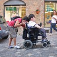 Francesco Berardi backs his friend Leonardo Stasi in his wheelchair down the steep via Mazzini as the wheels shimmy over the dark-cobblestones. The feat is difficult – moving about 50 yards backwards the whole way.