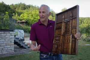 Ubaldo Ricci displays one of his wood carved pieces.