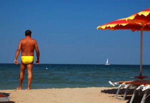 A man prepares for a swim in the Adriatic Sea. 