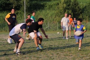 The two Titans, the men’s team and the mini team, get together to play a game of touch rugby. 