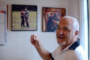 The walls of Tito Micheli's home office are covered in pictures of his family, including this one of him with his daughter, Silvia, on a hunting trip.