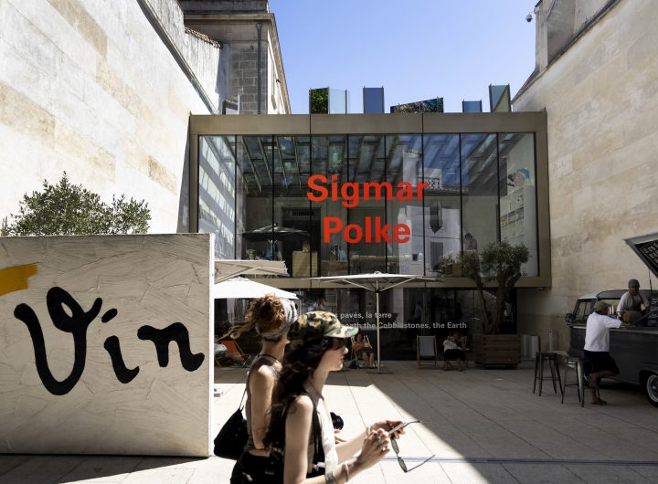 A woman walks in front of a museum