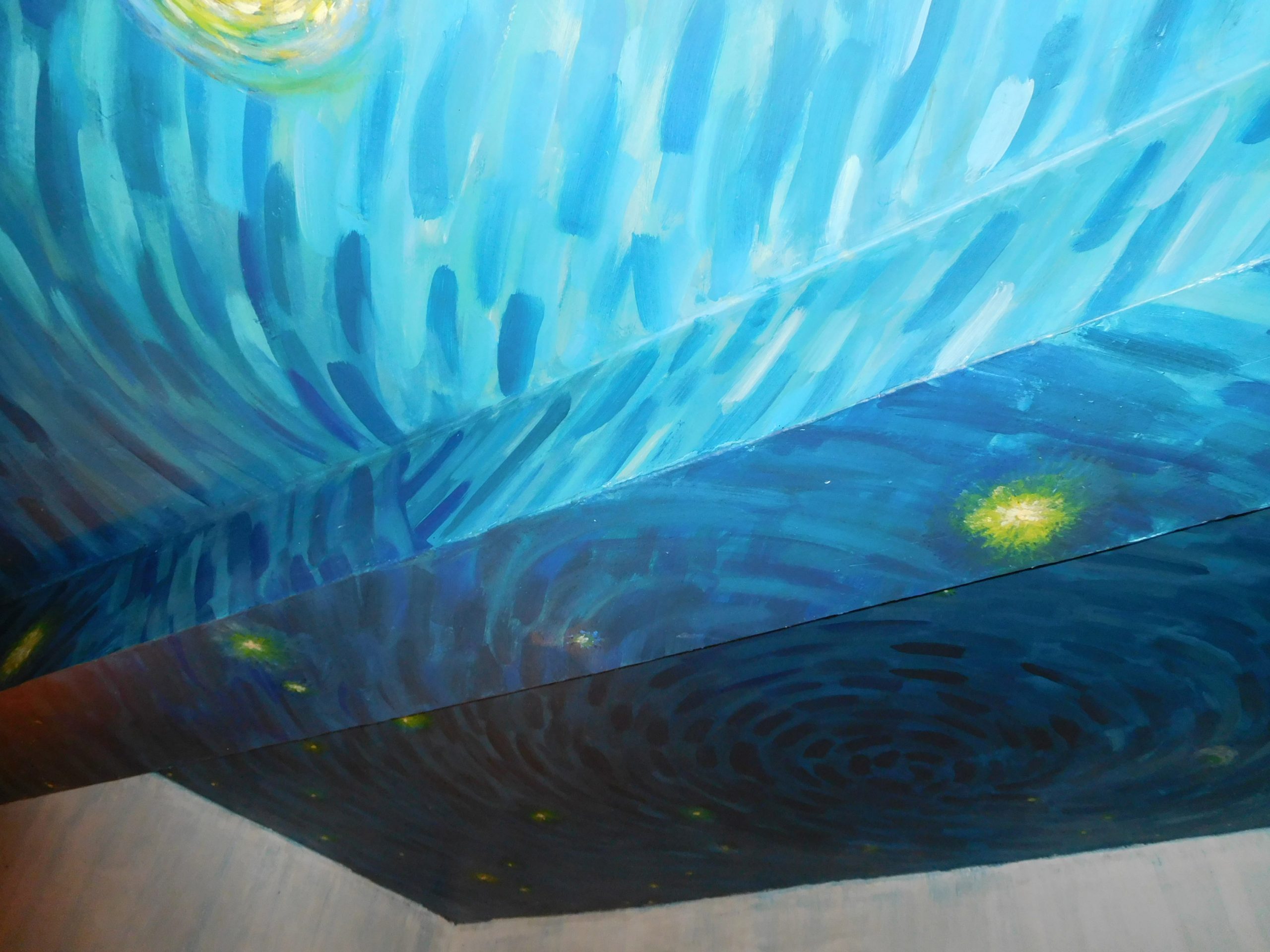 The ceiling of the Airbnb replica of Van Gogh's bedroom is painted in swirls.