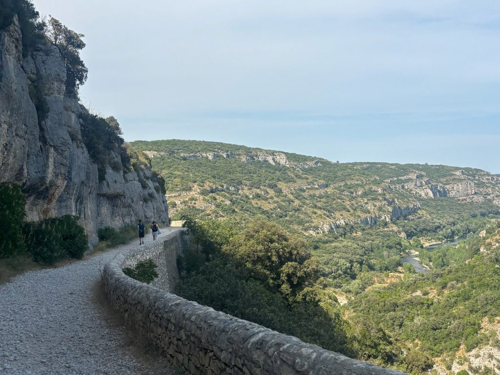 A rocky, winding path leads to a hidden swimming hole.
