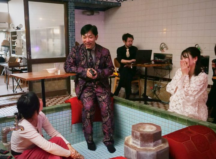 People gather in a tub at an old Japanese bathhouse.