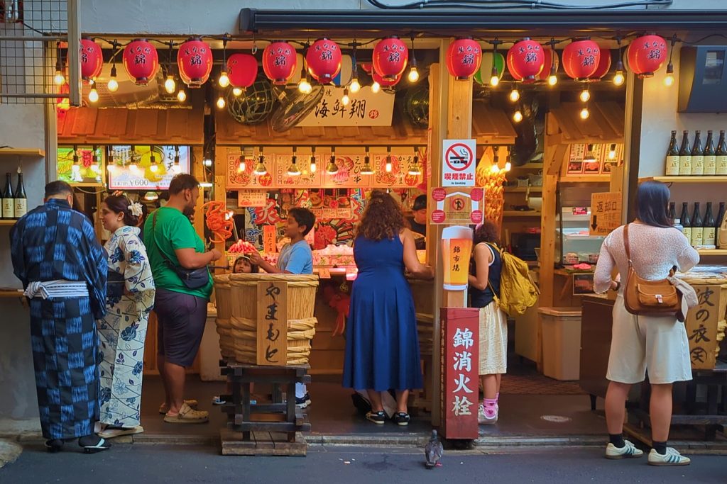 Tourists crowd into a Nishiki Market stall in a photo by Ben Lyle.