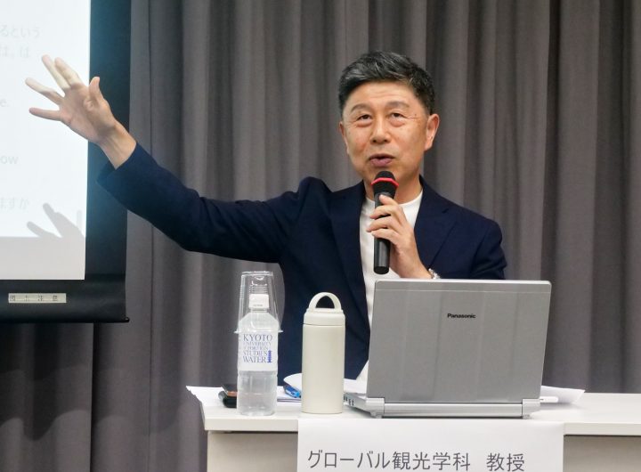 Toshihiko Goto, gestures at the panel discussion.