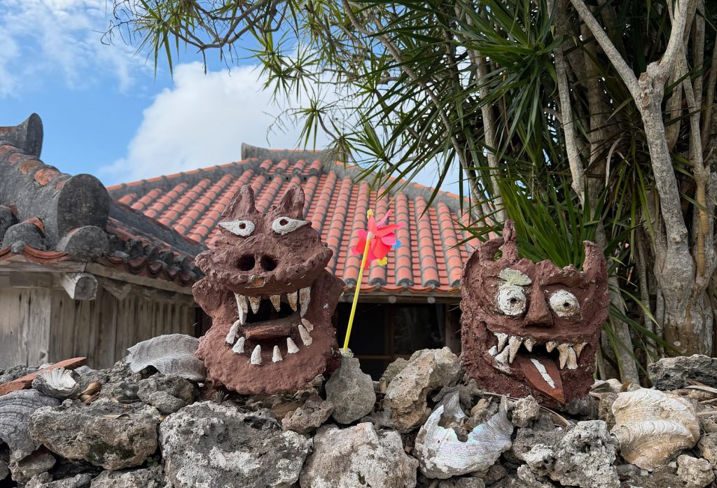 Two shisa statues, traditional Okinawan guardian lion-dogs believed to ward off evil spirits and bring good fortune, stand watch on the island of Taketomi. One has its mouth open to ward off evil spirits.The other has its mouth closed to keep good fortune inside.