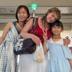Emma Cooney, center, stands with her new friends, Aoi, left, and her daughter, Sumi, right at the ferry port on Taketomi.