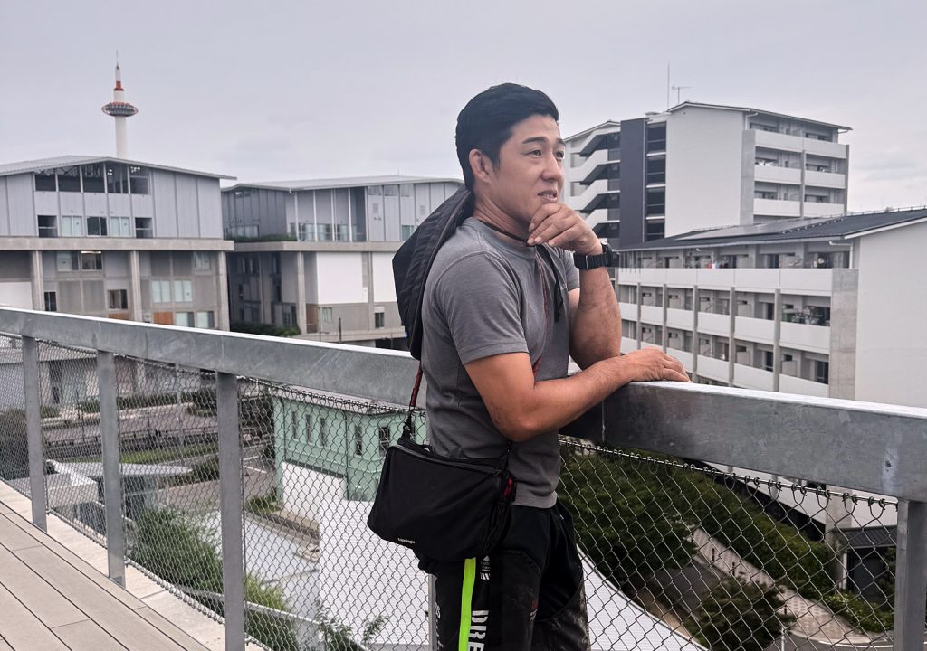 Ryuichiro Ando looks into the distance from a balcony.